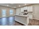 Modern kitchen features an island, granite countertops, stainless steel appliances and dark hardwood flooring at 4554 Eastbrook Pl, Snellville, GA 30039
