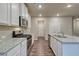 Modern kitchen with granite countertops, stainless steel appliances, and hardwood floors at 4554 Eastbrook Pl, Snellville, GA 30039