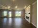 Open living space featuring hardwood floors, a contemporary fireplace, and ample natural light at 4554 Eastbrook Pl, Snellville, GA 30039