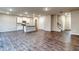 Open-concept living space with hardwood floors connecting the kitchen and staircase at 4554 Eastbrook Pl, Snellville, GA 30039