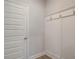 Mudroom featuring coat hooks, paneled wall and a white door at 4554 Eastbrook Pl, Snellville, GA 30039