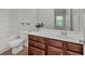 Classic bathroom with cherry wood cabinets, white counters, and standard bath at 2555 Flat Shoals Road Rd # 1104, College Park, GA 30349