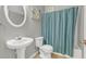 Bathroom with a white pedestal sink, commode, and a blue shower curtain at 2555 Flat Shoals Road Rd # 1104, College Park, GA 30349