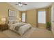 A staged bedroom with vaulted ceiling features a ceiling fan, a window, and neutral paint at 2555 Flat Shoals Road Rd # 1104, College Park, GA 30349