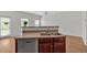 Kitchen island featuring a stainless steel dishwasher and sink, alongside sleek wood cabinets at 2555 Flat Shoals Road Rd # 1104, College Park, GA 30349