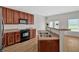 Kitchen with stainless steel appliances, wooden cabinets, breakfast bar, and natural light at 2555 Flat Shoals Road Rd # 1104, College Park, GA 30349