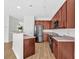 Kitchen featuring stainless steel appliances, wooden cabinetry, and bar seating area at 2555 Flat Shoals Road Rd # 1104, College Park, GA 30349