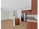 Open concept kitchen featuring stainless appliances, wooden cabinetry, and adjacent living area at 2555 Flat Shoals Road Rd # 1104, College Park, GA 30349