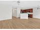 Open-concept living room with ceiling fan and adjacent kitchen featuring wooden cabinets at 2555 Flat Shoals Road Rd # 1104, College Park, GA 30349