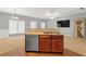 Open-concept living area featuring a wet bar, hardwood floors, and multiple windows at 2555 Flat Shoals Road Rd # 1104, College Park, GA 30349