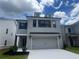 Charming two-story home featuring a finished garage and neutral gray painted brick at 4524 Eastbrook Pl, Snellville, GA 30039