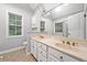 Bathroom featuring double sink vanity, a large mirror, and natural light at 4544 Dorsett Shoals Run, Douglasville, GA 30135