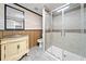 Rustic bathroom featuring wood paneling, a glass shower, and custom vanity at 4544 Dorsett Shoals Run, Douglasville, GA 30135