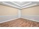 This bedroom boasts hardwood floors, neutral walls, and decorative tray ceiling at 4544 Dorsett Shoals Run, Douglasville, GA 30135