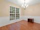 Elegant dining room with hardwood floors, wainscoting, chandelier, and large window at 4544 Dorsett Shoals Run, Douglasville, GA 30135