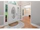 Bright entryway with decorative glass front door, sidelights, hardwood floors and chandelier view to dining room at 4544 Dorsett Shoals Run, Douglasville, GA 30135
