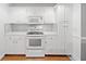Bright kitchen featuring white cabinets, countertops, range and hardwood floors at 4544 Dorsett Shoals Run, Douglasville, GA 30135