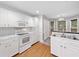 Kitchen with white cabinetry, countertops, modern appliances, and natural light at 4544 Dorsett Shoals Run, Douglasville, GA 30135