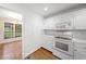 Cozy kitchen showcasing white cabinetry and breakfast nook view at 4544 Dorsett Shoals Run, Douglasville, GA 30135