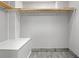 Bright, spacious walk-in closet with wood shelving and built-in bench at 4544 Dorsett Shoals Run, Douglasville, GA 30135