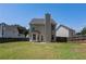 Exterior of home with a fenced-in backyard and lush green grass at 752 Wood Bend Ct, Riverdale, GA 30296