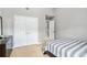 Neutral bedroom with white trim, a double door closet, and a light gray striped comforter at 752 Wood Bend Ct, Riverdale, GA 30296