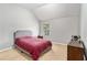 Bedroom with vaulted ceiling, gray upholstered bed, and minimal decor at 752 Wood Bend Ct, Riverdale, GA 30296
