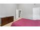 Bedroom with gray walls, a red comforter, and an doorway to another room at 752 Wood Bend Ct, Riverdale, GA 30296