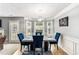 Bright dining room featuring a marble table, blue chairs, and three large windows offering great natural light at 752 Wood Bend Ct, Riverdale, GA 30296