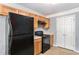 Kitchen with black appliances, wood cabinets, double door pantry and laminate countertops at 752 Wood Bend Ct, Riverdale, GA 30296