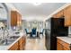Bright kitchen with wood cabinets and an open view of the dining room and backyard at 752 Wood Bend Ct, Riverdale, GA 30296