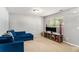 A cozy living room with a plush blue couch, beige carpet and large window for natural light at 752 Wood Bend Ct, Riverdale, GA 30296