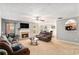Spacious living room with neutral carpet, fireplace, ceiling fan and comfortable sofas with open access to the kitchen at 752 Wood Bend Ct, Riverdale, GA 30296
