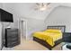Comfortable main bedroom with a yellow comforter, vaulted ceilings, and a large dresser at 752 Wood Bend Ct, Riverdale, GA 30296