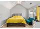 Comfortable main bedroom with a yellow comforter, ensuite sofa and vaulted ceilings at 752 Wood Bend Ct, Riverdale, GA 30296