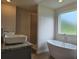 Bright bathroom featuring a freestanding tub, granite countertop, and a separate shower with tile surround at 1669 Fuma Leaf Way, Mcdonough, GA 30253