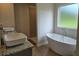 Bathroom boasts double sinks on granite countertop, a glass-enclosed shower, and a luxurious tub at 1669 Fuma Leaf Way, Mcdonough, GA 30253