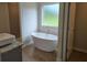 Modern bathroom featuring a freestanding tub and stylish fixtures at 1669 Fuma Leaf Way, Mcdonough, GA 30253