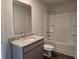 Bathroom featuring a granite countertop, sink, mirror, and a shower-tub combo at 1669 Fuma Leaf Way, Mcdonough, GA 30253