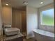 Bright bathroom featuring a freestanding tub, granite countertop, and a separate shower with tile surround at 1669 Fuma Leaf Way, Mcdonough, GA 30253