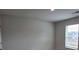 Bright bedroom with a window overlooking nearby houses at 1669 Fuma Leaf Way, Mcdonough, GA 30253
