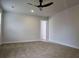 Spacious bedroom featuring plush carpet, a modern ceiling fan, and neutral paint at 1669 Fuma Leaf Way, Mcdonough, GA 30253