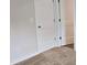 Bedroom with neutral walls, plush carpeting, with a door and a closet at 1669 Fuma Leaf Way, Mcdonough, GA 30253