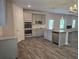 Modern kitchen with stainless steel appliances, granite countertops, an island, and hardwood floors at 1669 Fuma Leaf Way, Mcdonough, GA 30253