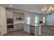 Well-lit kitchen features stainless steel appliances, granite countertops, and an island with a sink at 1669 Fuma Leaf Way, Mcdonough, GA 30253