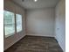 Bright living room features hardwood floors, large windows, and fresh, neutral paint at 1669 Fuma Leaf Way, Mcdonough, GA 30253
