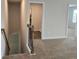 Carpeted staircase leads to a bright upper level with access to multiple rooms and natural light at 1669 Fuma Leaf Way, Mcdonough, GA 30253