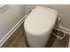 A modern toilet with a bidet feature is elegantly displayed on a wooden floor at 1669 Fuma Leaf Way, Mcdonough, GA 30253
