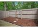 Fenced backyard features a mulched area with stepping stones, providing a private outdoor space at 1771 Defoor Nw Ave # D, Atlanta, GA 30318