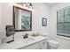 Modern bathroom features a large mirror, ample lighting, and a tropical-themed shower curtain at 1771 Defoor Nw Ave # D, Atlanta, GA 30318